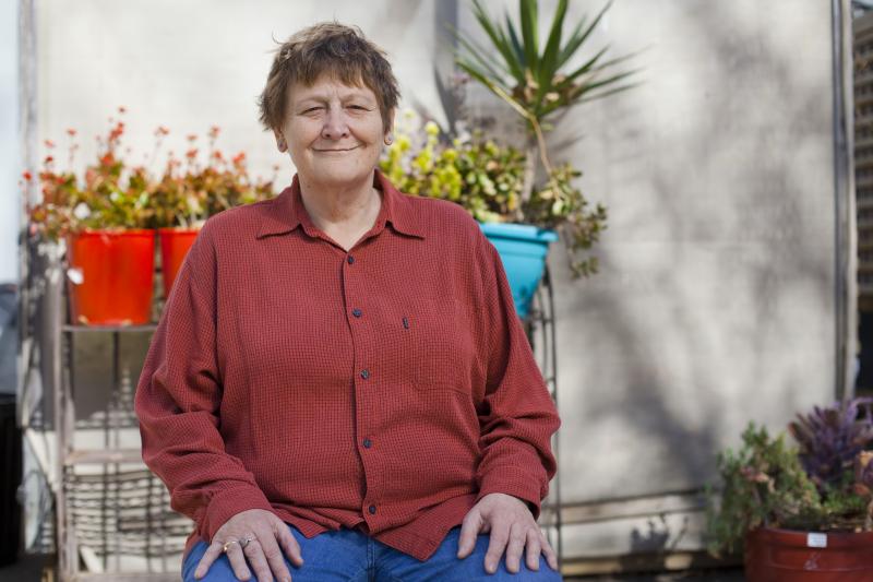 A woman sitting and smiling