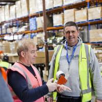 Three men in a warehouse