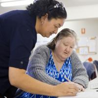 Two women filling in a form