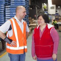 Two people in a warehouse