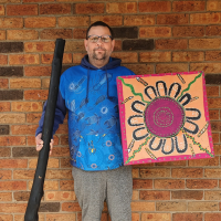 Nathaniel holding Abroginal artwork