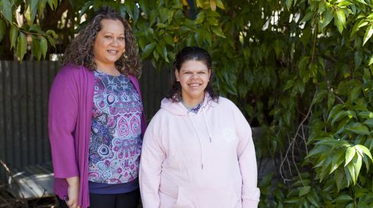 Two women smiling at the camera