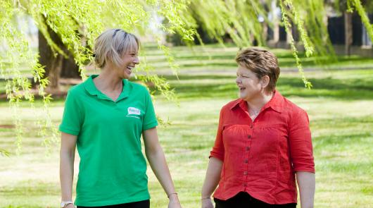 Two women walking in the park