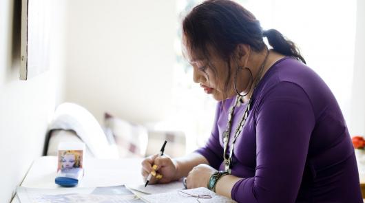 A woman writing at a table